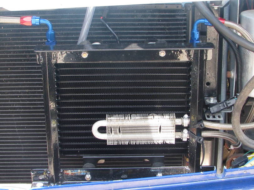 Cooler mounted in front of AC condensor