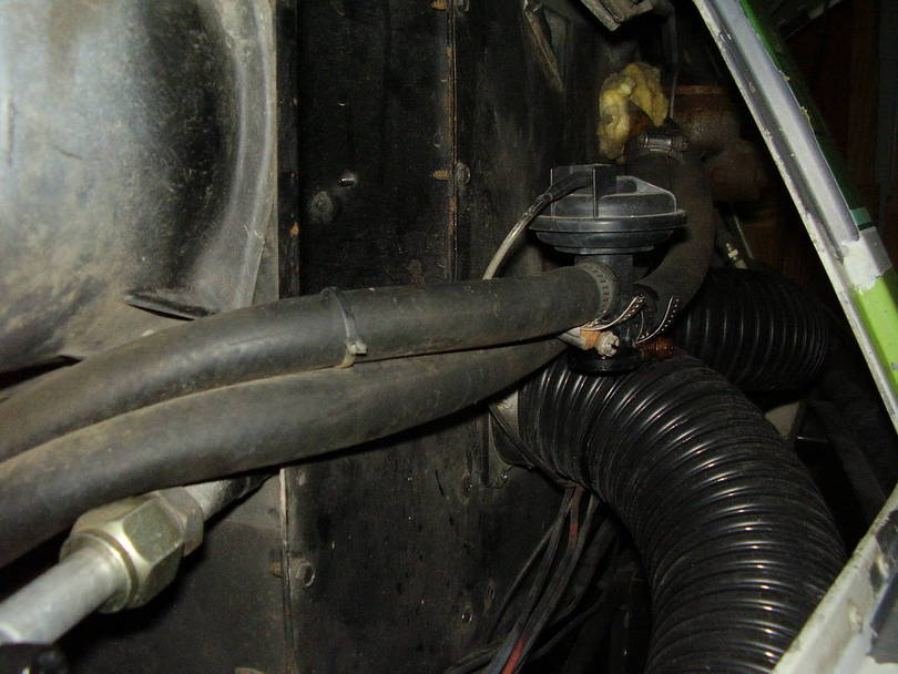 Hose and flange bolted to passenger side HVAC box