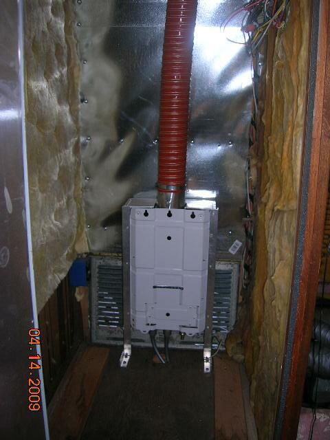 Interior pictures of Rays tankless water heater installation behind refrige