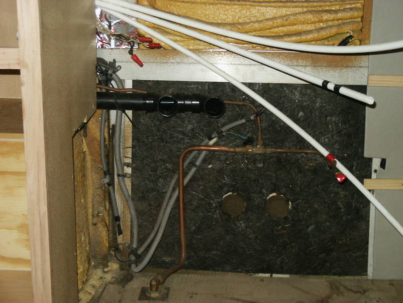 Left cabinet in place showing how utilities are run behind.