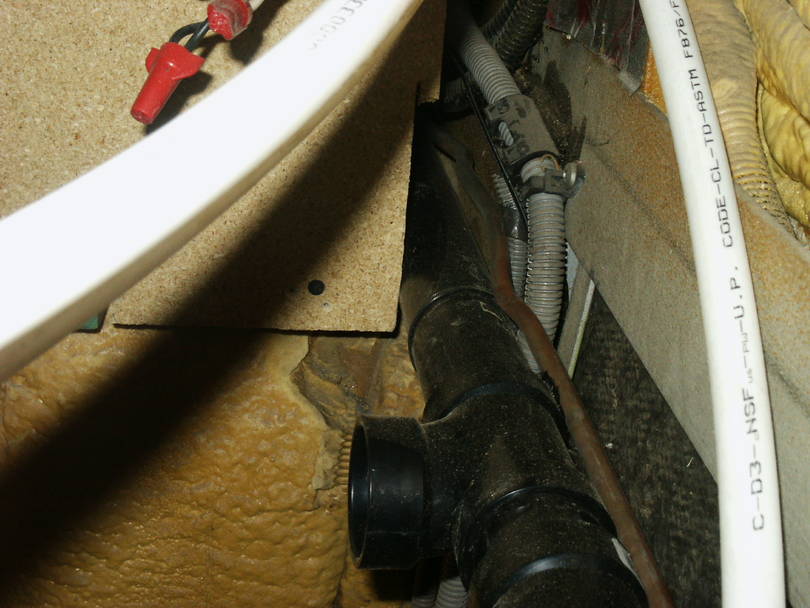 Left cabinet in place showing how utilities are run behind.