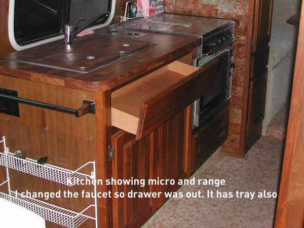 Kitchen area with micro and range, drawer out to change faucet