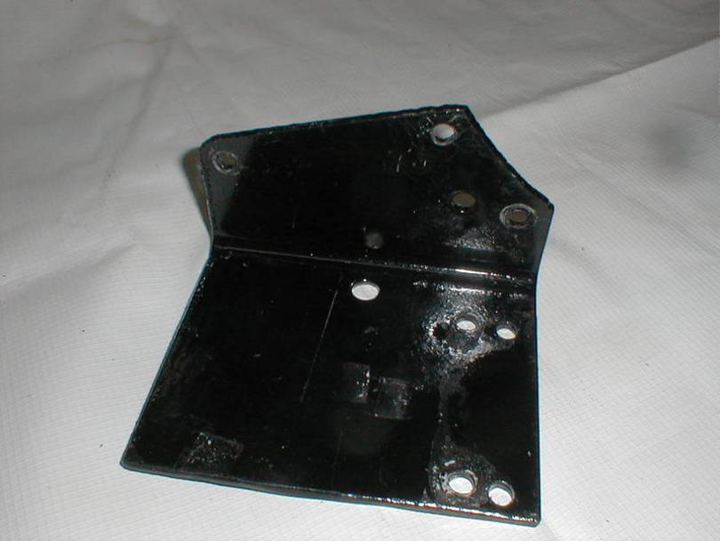 A better location is beside the frame ahead of the left wheel well liner.