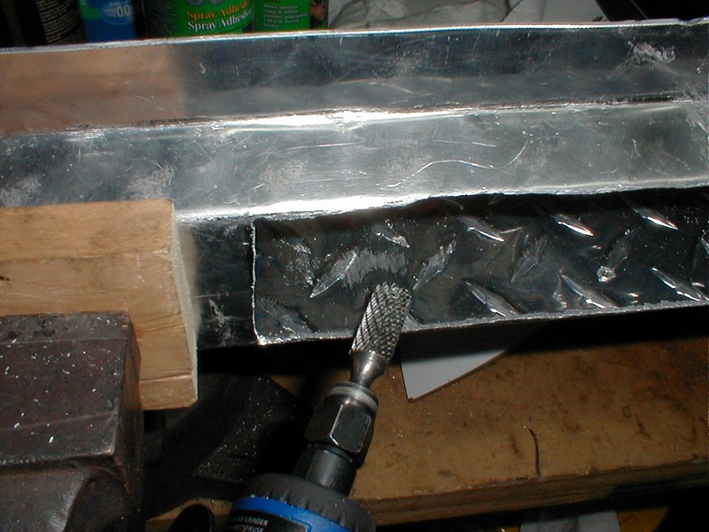 Air driven carbide burr to clean up saber saw mess