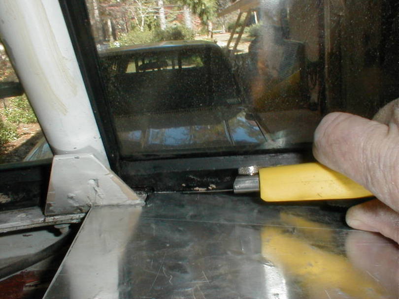 Trimming the windshield rubber for dash top clearance.
