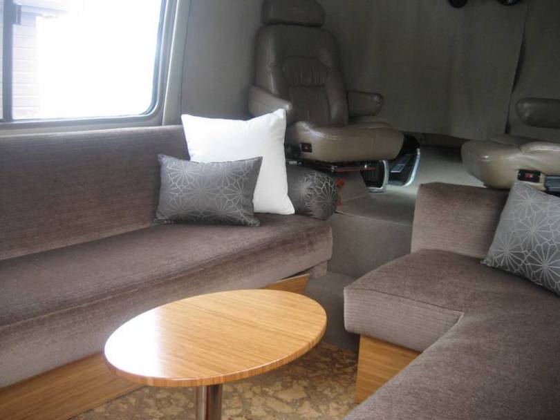 Living area with cocktail table and custom j couch