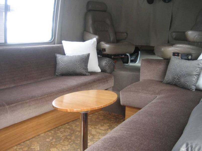 Living area with cocktail table and custom j couch