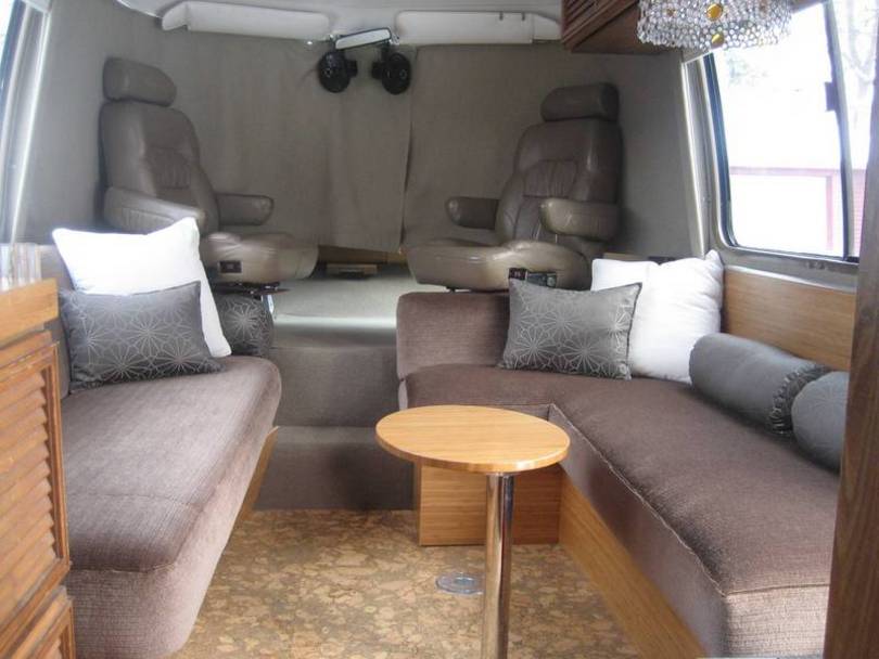 Living area with cocktail table and custom j couch