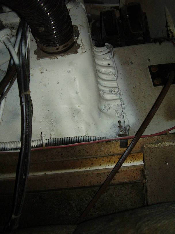Hose and flange bolted to drivers side floor (view from below)