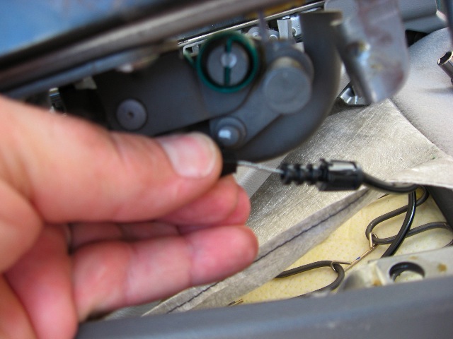 The black clip slides forward, off the metal stud.