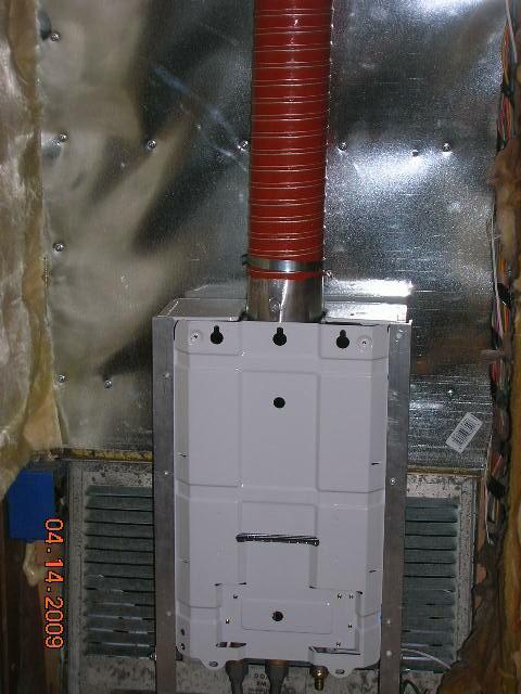 Interior pictures of Rays tankless water heater installation behind refrige
