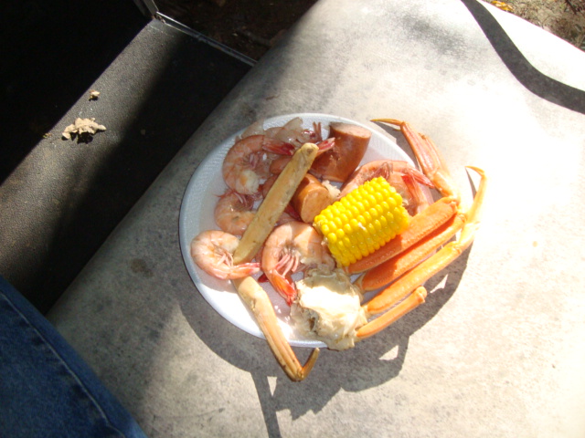 boiled shrimp, crab legs, kabasa, and corn on the cob
