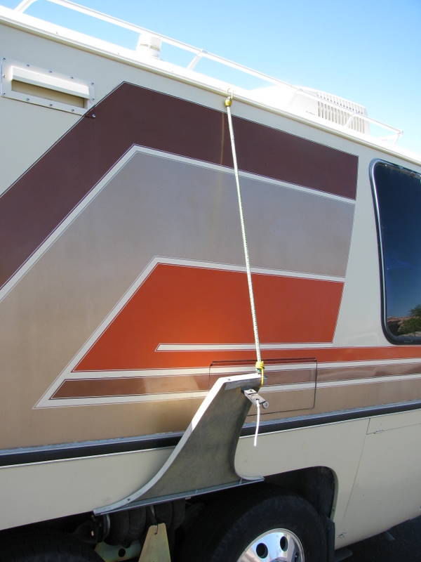 A bungee cord holds it up to the rain gutter.