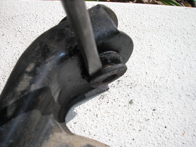 Removing the flange washers from the A-arm bushings