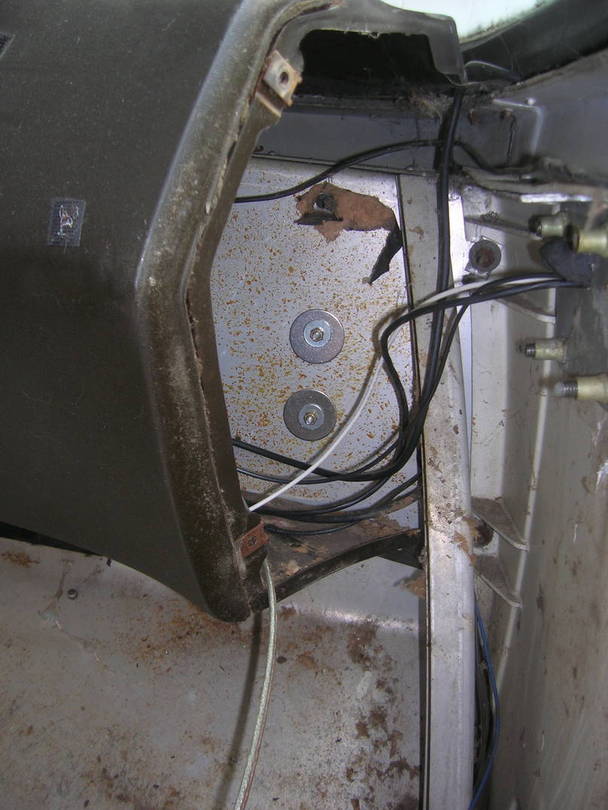 Location of two side panel retaining screws on end of dash