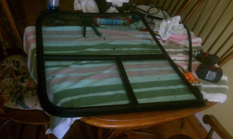 Cockpit windows being re sealed and painted frames