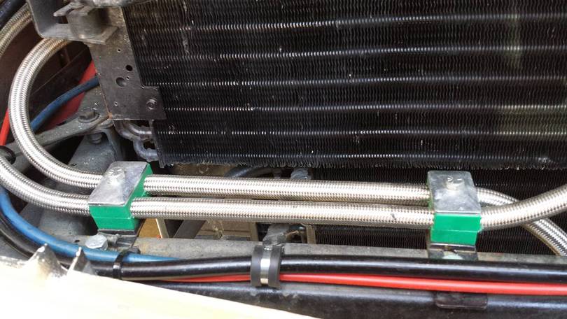 Clamping hoses to frame