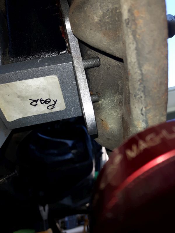 Bolts run into the backing plate