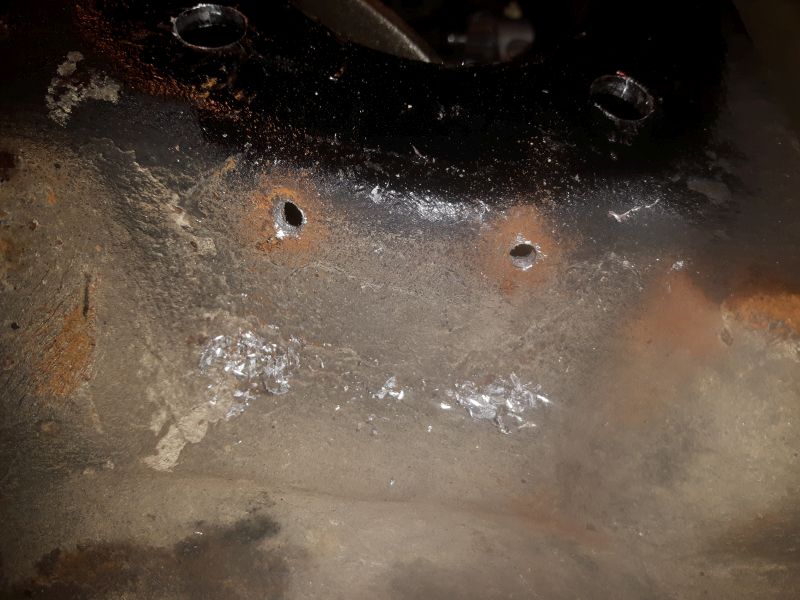Pilot holes drilled in backing plate